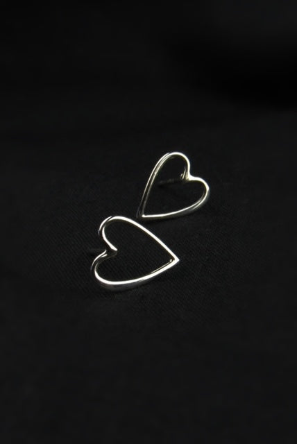 Heart-shaped earrings on a black background