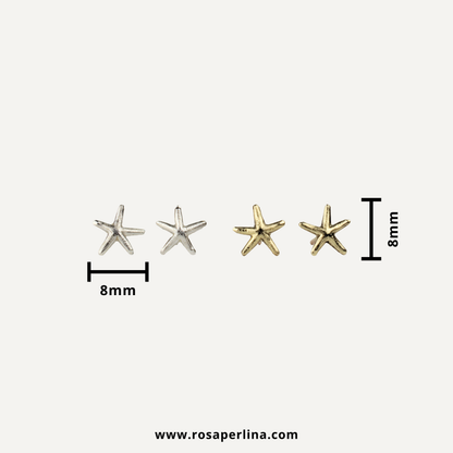Two small starfish-shaped stud earrings shown on a light gray background, with size markers indicating 8mm width for the silver pair and 8mm height for the gold pair. 
