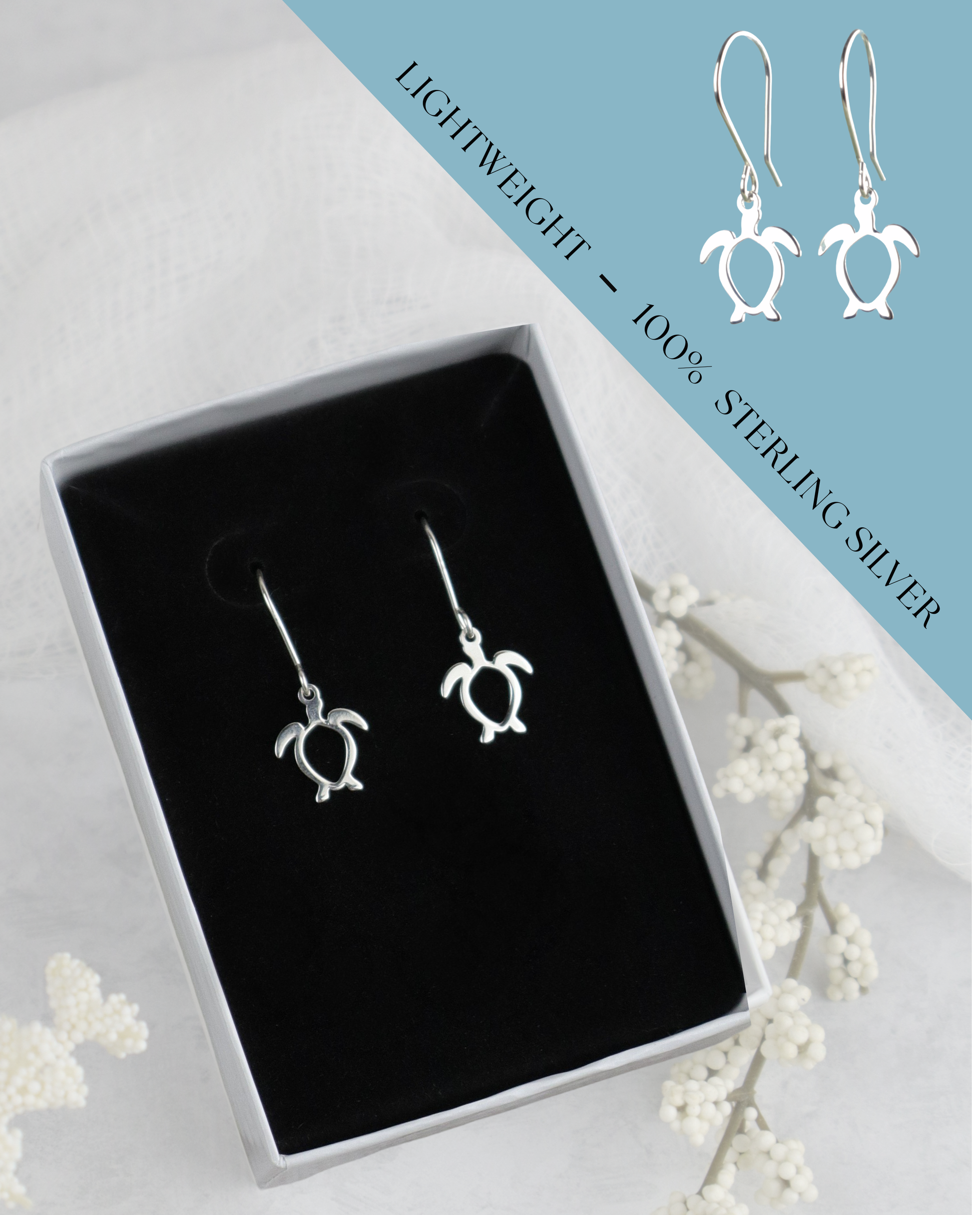 Silver turtle earrings in a box with a blue card detailing weight and material.