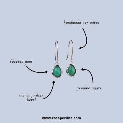 Green teardrop earrings with silver bezels on a light blue background, labeled with materials.