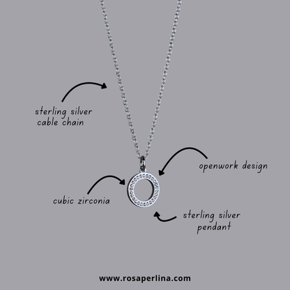 Silver necklace with pendant on a gray background, labeled with features and brand.