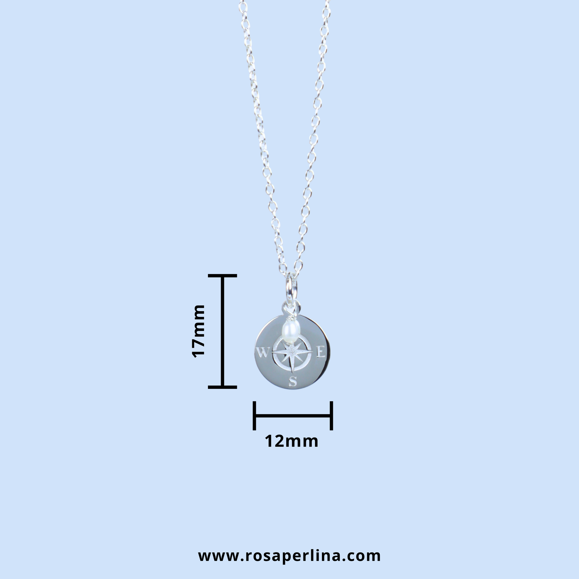 Silver compass pendant necklace on a delicate chain, shown with dimension lines indicating a height of 17mm and width of 12mm, on a light blue background.