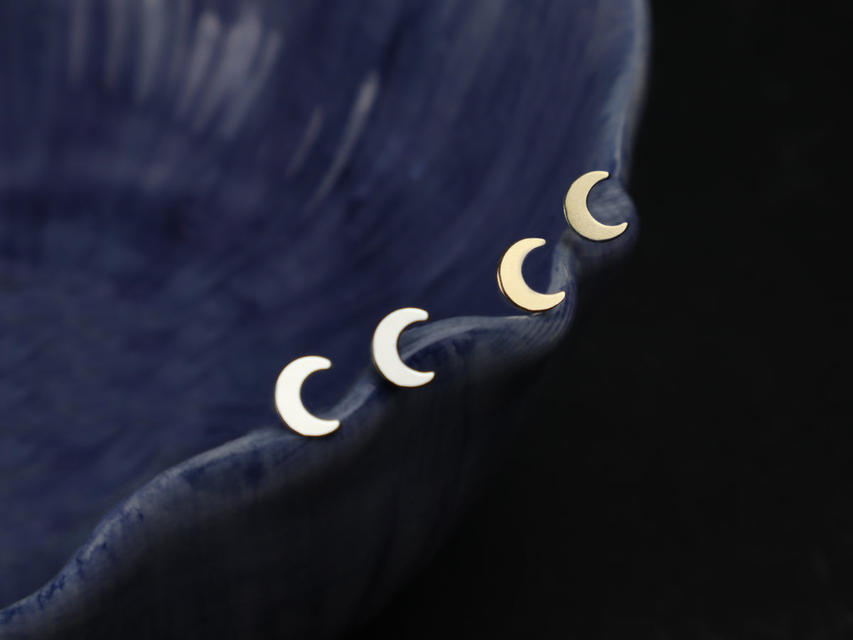 moon earrings picture on a dark background 