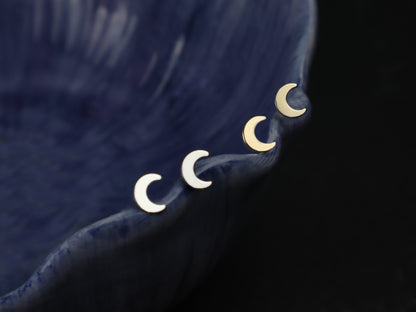 moon earrings picture on a dark background 