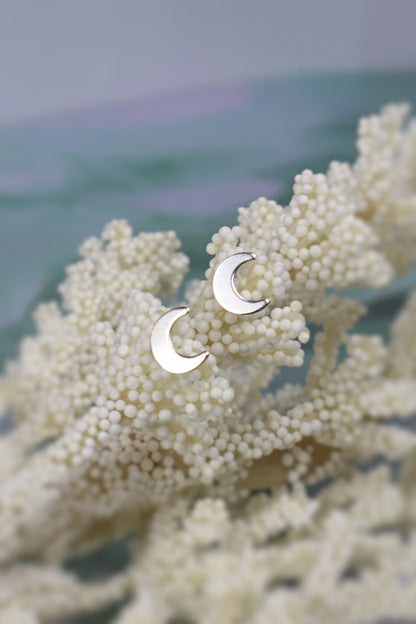 sterling siler moon earrings on a white floral background
