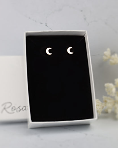 silver moon earrings in a black and white jewelry box