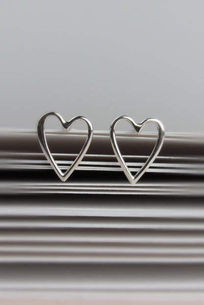 Two silver heart-shaped earrings 