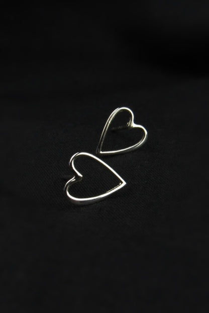 Heart-shaped earrings on a black background