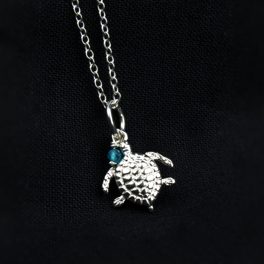 sterling silver turtle pendant with blue gemstone